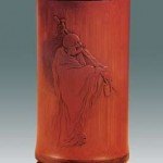 Qing Dynasty brush pot with a relief showing a monk carrying a staff, housed in Palace Museum